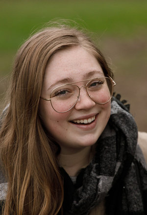 18 year old female Doris G slips off her underwear to pose naked on her bed